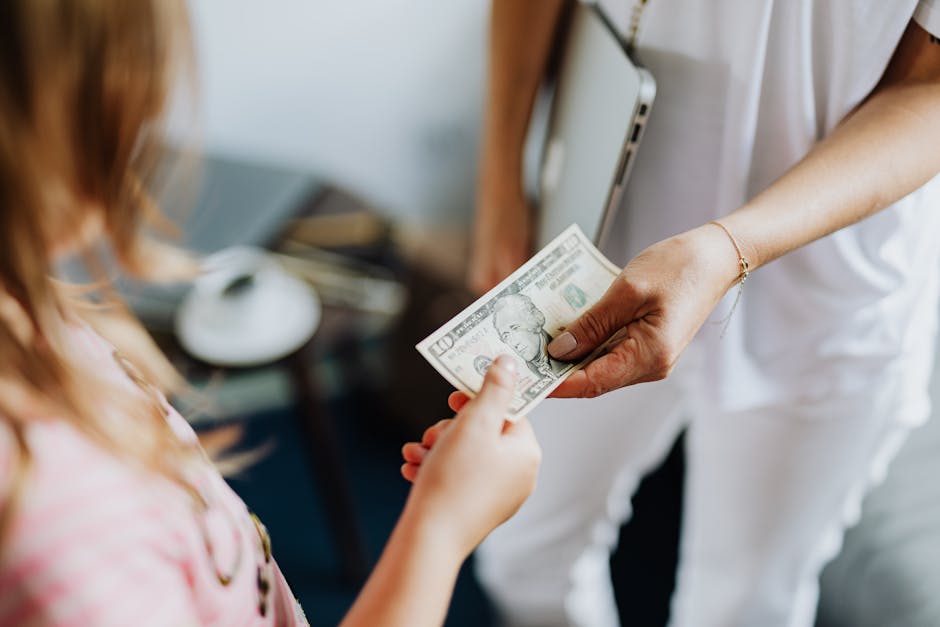 Close-up of a transaction involving a US dollar bill exchanged indoors between two individuals.
