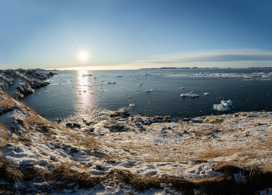A woman in Nuuk, Greenland, smiles warmly in a winter coat at twilight.