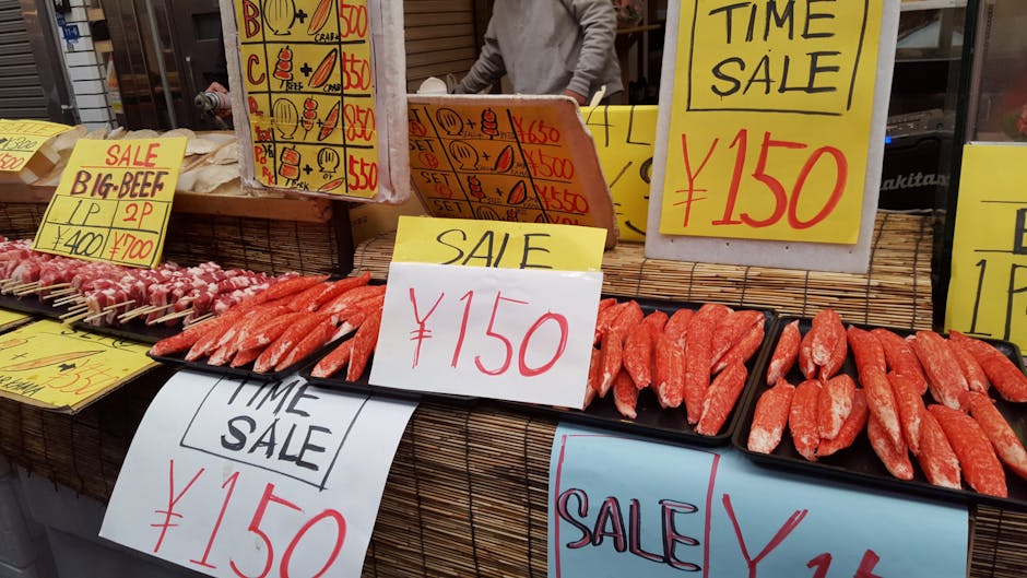 Outdoor market stall featuring seafood and beef skewers on sale with vibrant signage in Japanese Yen.