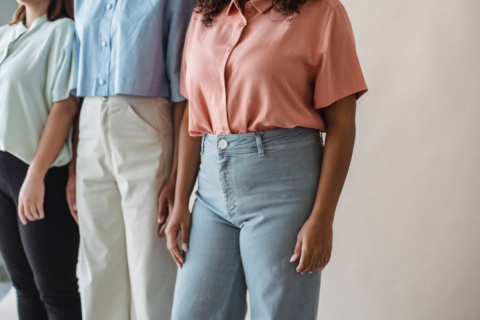 Close-up of a person's torso wearing a blue shirt with a braided belt and khaki pants.
