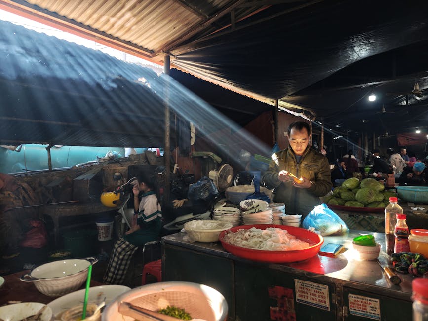 Bustling indoor market with people and vibrant sunlight beams, capturing daily life ambiance.