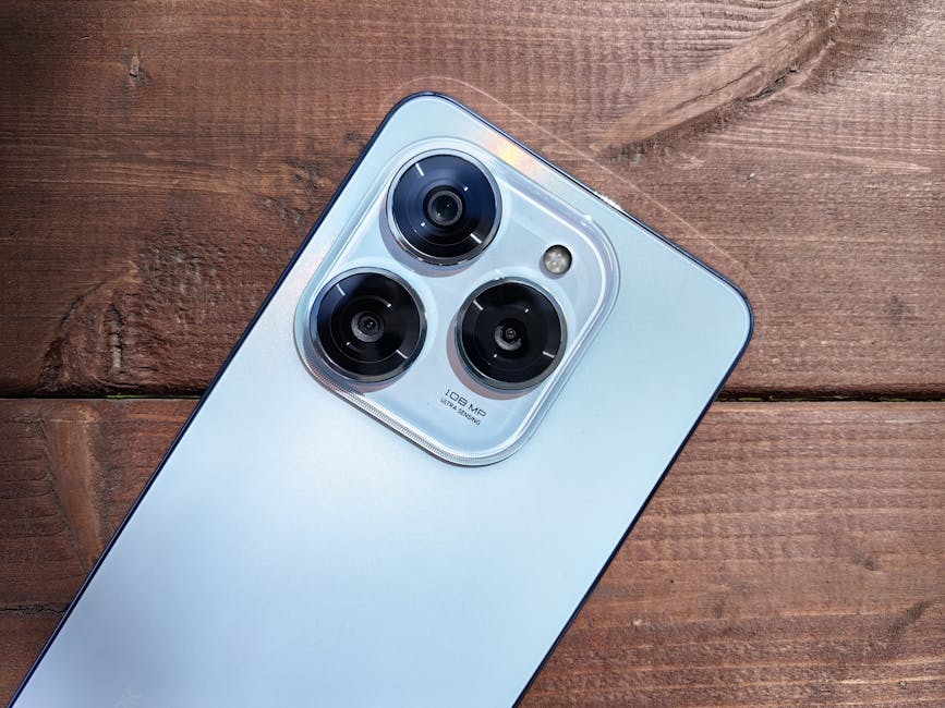 Close-up of a smartphone camera showing three lenses on a rustic wooden background.