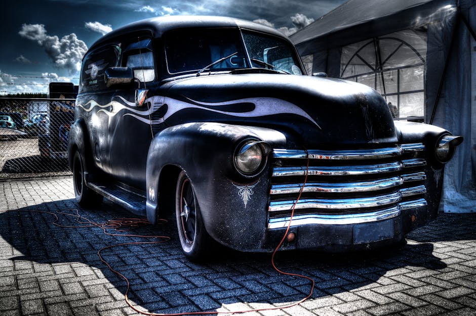 Vintage classic car with bold design captured in HDR outdoors under dramatic skies.